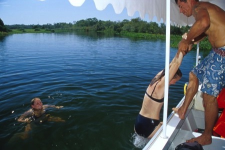 Tourists swimming in a Pantanal river while on a boat trip out of Corumbá.